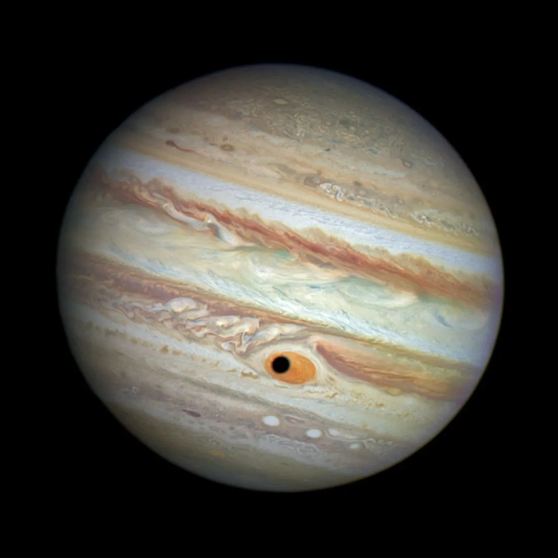 Reference image of Jupiter from Hubble showing the Great Red Spot and cloud bands, with the shadow of Ganymede on the disk