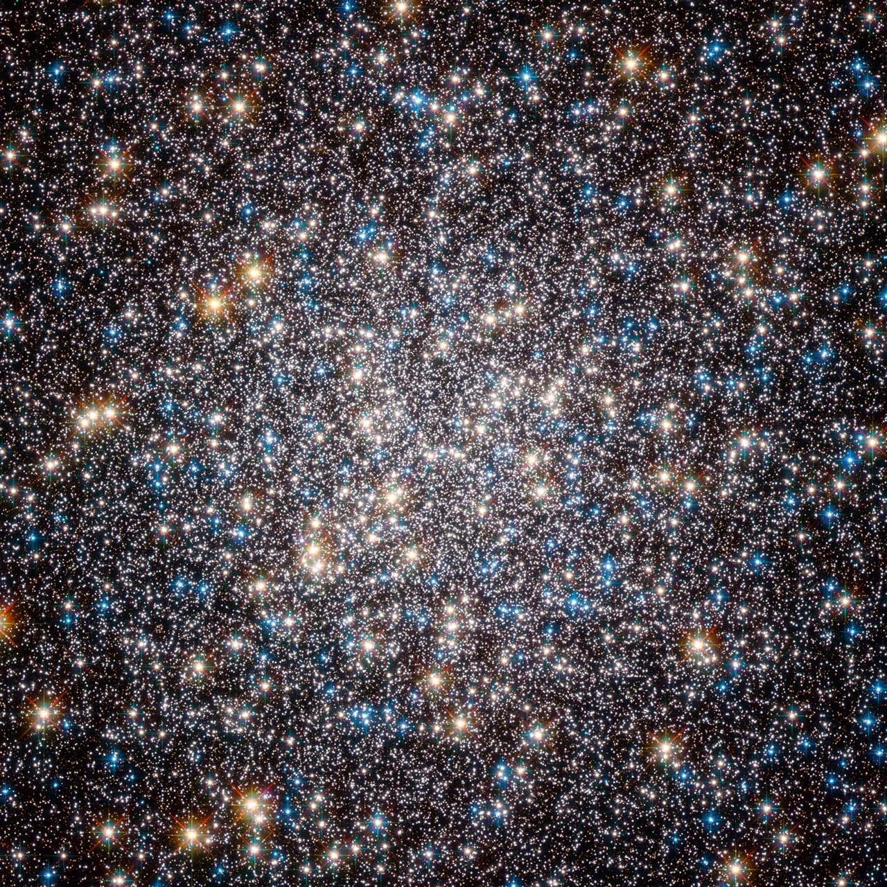 Reference image of the Hercules Globular Cluster (M13) from Hubble, showing hundreds of thousands of stars packed into a dense sphere