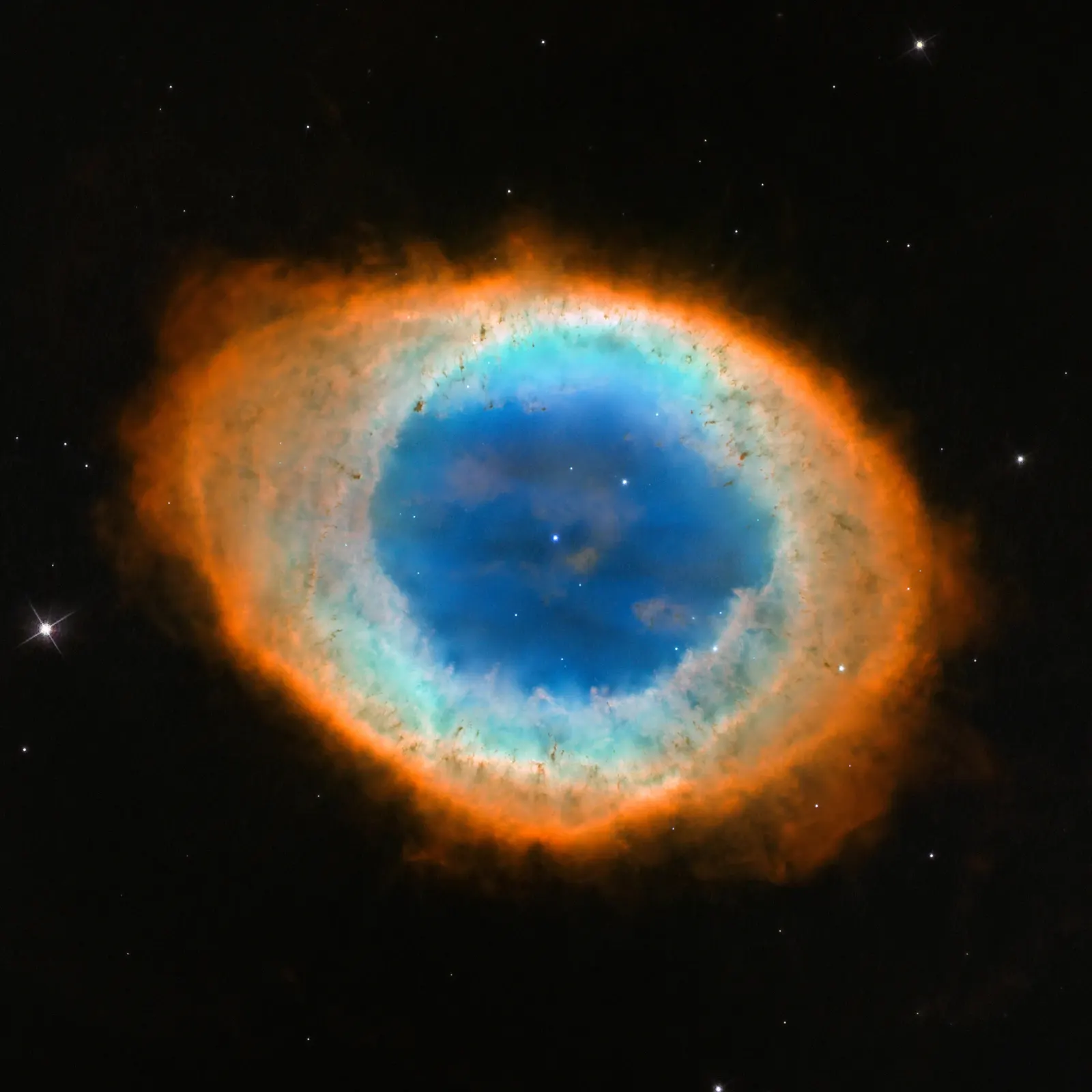 Reference image of the Ring Nebula (M57) from Hubble, showing the classic ring-shaped shell of gas from a dying star